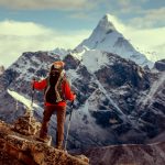 Hiker posing at camera on the trek in Himalayas, Nepal