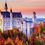 Germany. Famous Neuschwanstein Castle in the background of trees